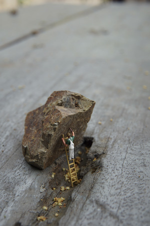 Miniature figure working in industrial sector - Close up of cleaning painting worker concept with selective focus.の写真素材