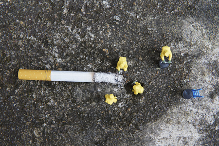 Miniature figures working in industrial - Top view of Hazardous Material (HAZMAT) teamwork concept with half cigarette on the floor.の写真素材