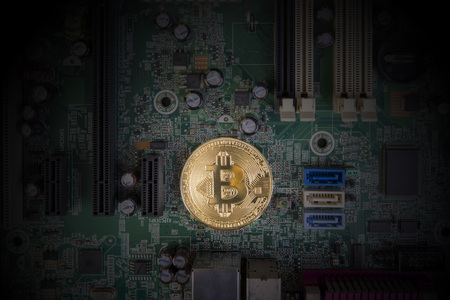 Cryptocurrency Business Concept - Shining golden Bitcoin with dark background circuit board.の写真素材