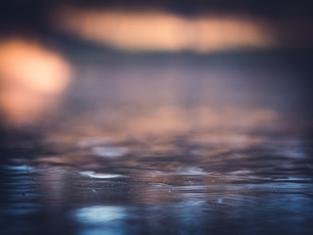 A small pond has frozen with a thin layer of ice over night. Colorful reflections and perfect for background use. Location: The Botanical Gardens in Lund, Sweden.の写真素材