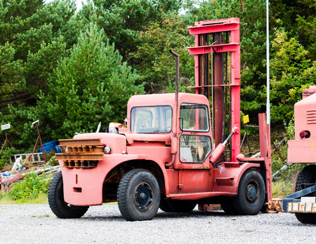 A really old, aged and worn red boat lifting truck at a dry dock  wharf.の写真素材