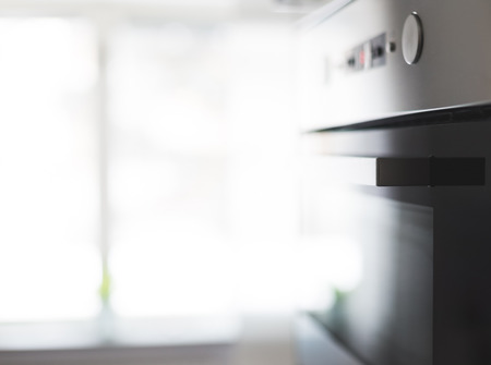 A clean aluminum finish oven in a bright Scandinavian kitchen. Location: Sweden.の写真素材