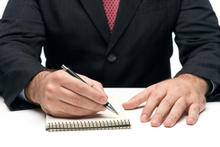 Man's Hands Holding A Pen Writing A Textの写真素材