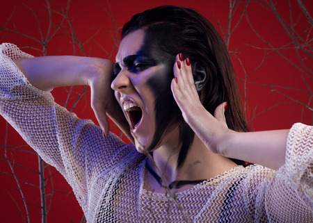 Fashion Beauty Screaming Model Girl Between Trees Over Red Background