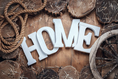 Word Home In Frame Of Stumps On Wooden Backgroundの写真素材