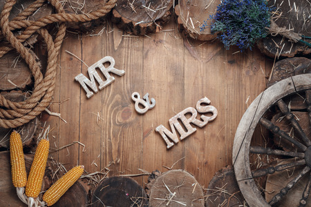 Wedding Words Mr And Mrs In Frame Of Stumps On Wooden Backgroundの写真素材