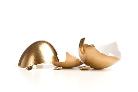 One Golden Broken Egg Isolated On White Backgrondの写真素材