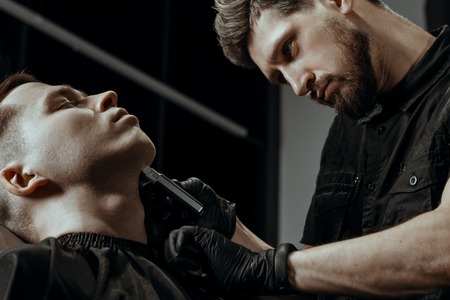 YOUNG HANDSOME MAN IN BARBERSHOPの写真素材