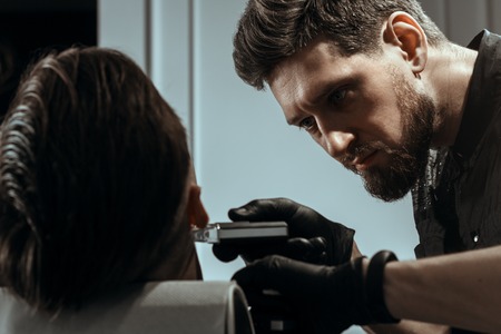 YOUNG HANDSOME MAN IN BARBERSHOPの写真素材