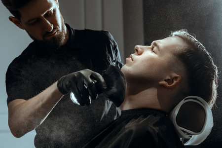 YOUNG HANDSOME MAN IN BARBERSHOPの写真素材