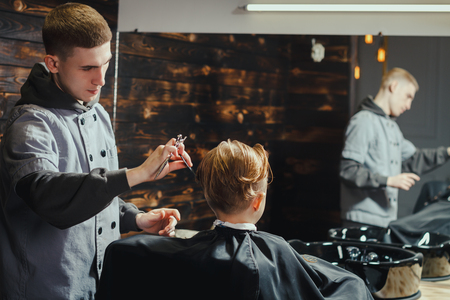 Little Boy Getting Haircut By Barberの写真素材