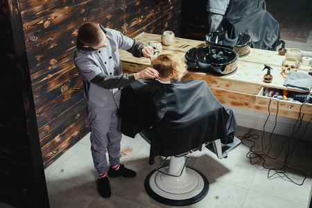 Little Boy Getting Haircut By Barberの写真素材