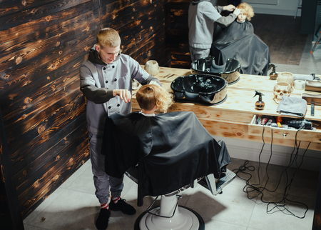 Little Boy Getting Haircut By Barberの写真素材