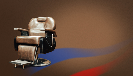 Stylish Vintage Barber Chair Isolated On Brown Background. Barbershop Themeの写真素材