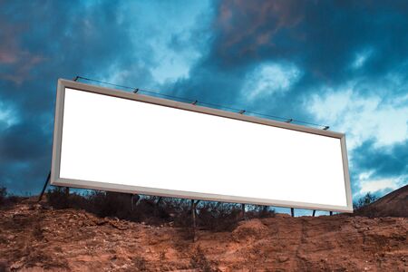 Blank white billboard on hill. Mock up. Poster near roadway. Empty space for text. Isolated white...