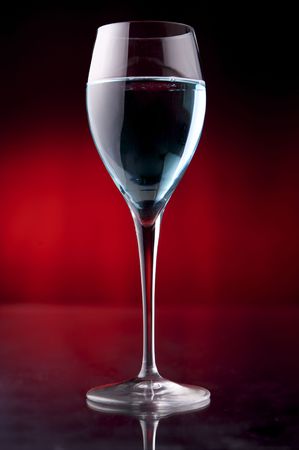 Wineglass with blue liquid on black backgroundの写真素材