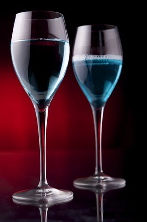 Wineglass with blue liquid on black backgroundの写真素材