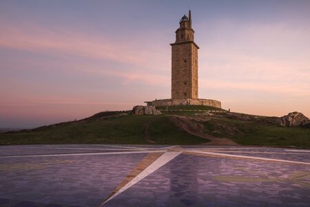 Hercules lighthouse tower in A Coruna at sunsetの写真素材