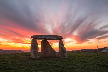 Dolmen at sunset with beautiful colors in the sky located in an outdoor park in A Corunaの写真素材