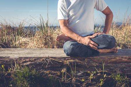 Man sitting in relaxing yoga position.の写真素材