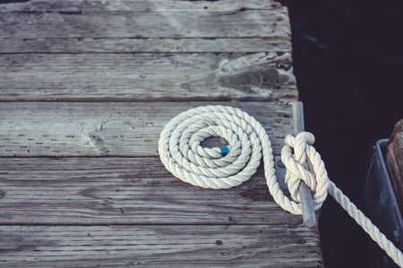 White coiled rope at a dock.の写真素材