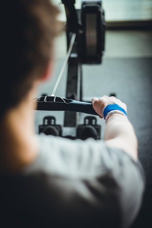 Man working out on a rowing machine.