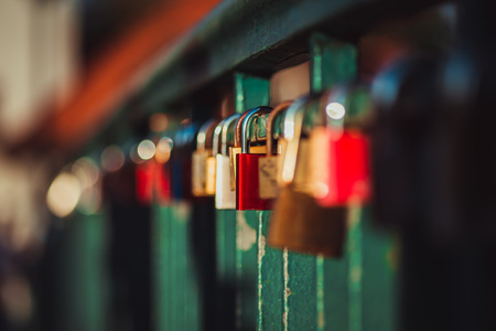 Padlocks fixed to the railings of bridge, Berlin, Germany. Shallow depth of field and creamy bokeh.の写真素材