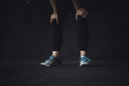 Working out in a cross fit box, lifting weights.の写真素材