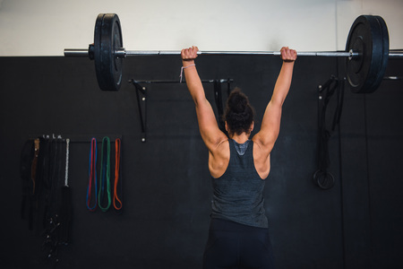 Lifting weights in cross fit gymの写真素材