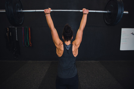 Lifting weights in cross fit gymの写真素材