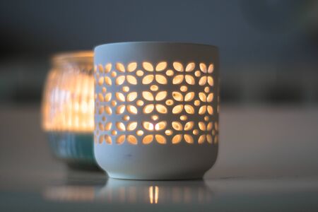 relaxing light of two candles lighting up at duskの写真素材