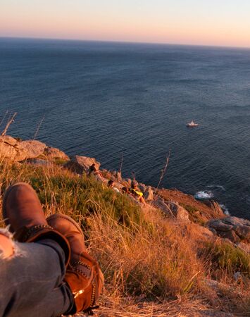 Watching the sunset from the Finisterre cliffの写真素材