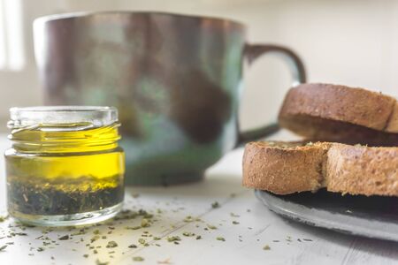 breakfast consisting of bowl of milk and toasts with oilの写真素材