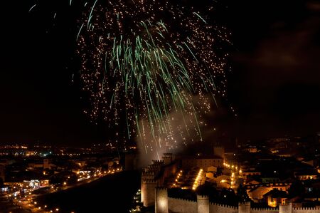 Fireworks from the festivities of Santa Teresa de Jesus over the city wall of ? vila, Spainの写真素材