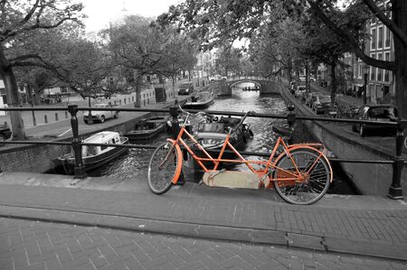 old orange bike on a street in Amsterdamの写真素材