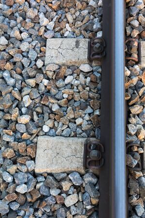 Textured wallpaper with stones and the train trackの写真素材