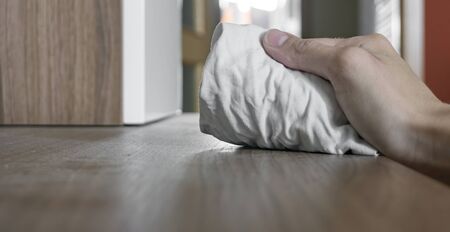 hand wiping dusty surface with ragの写真素材