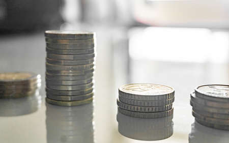 stack of coins on wooden table and blur backgroundの写真素材