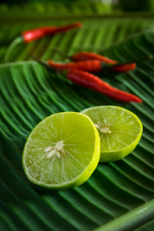 Chili and lime on banana leafの写真素材