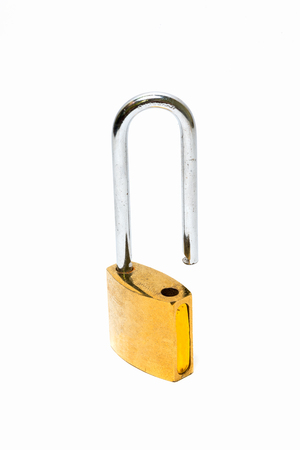 A goldyellow padlockcombination lock, bicycle lock locked isolated white at the studio.の写真素材