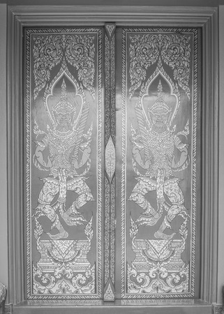 Ancient Gold carving wooden door of Thai temple , black and whiteのeditorial素材