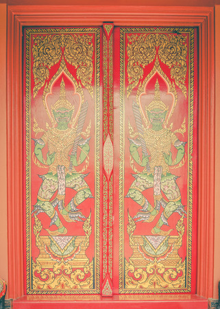 Ancient Gold carving wooden door of Thai temple ,vintageのeditorial素材