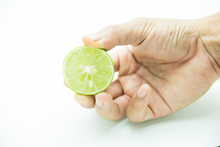 slices of lime in human handの写真素材