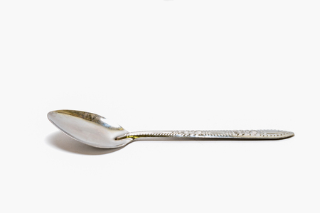old silver spoon isolated on white with clipping pathの写真素材
