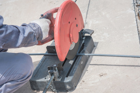 cutting a metal and steel with compound mitre saw with sharp, circular bladeの写真素材
