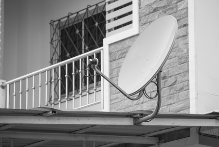 Green satellite dish on the roof , black and whiteの写真素材