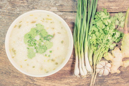 Traditiona porridge rice gruel in bowl on wooden background ,vintageの写真素材