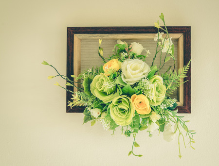 Fake flowers with white wall ,vintageの写真素材