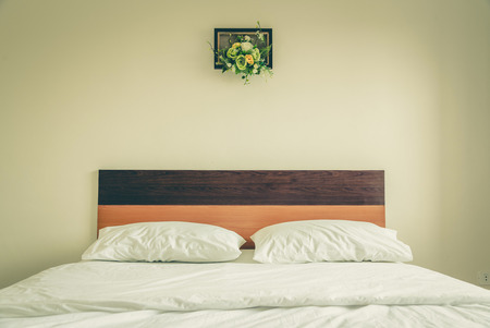Stylish white bedroom with a white bed ,vintageの写真素材