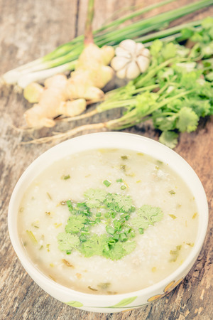Traditiona porridge rice gruel in bowl on wooden background ,vintageの写真素材